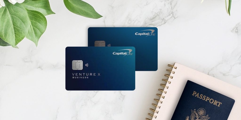 Venture X and Venture X business cards with a floral arrangement, notebook, and passport.