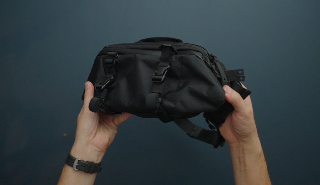 hands holding black sling