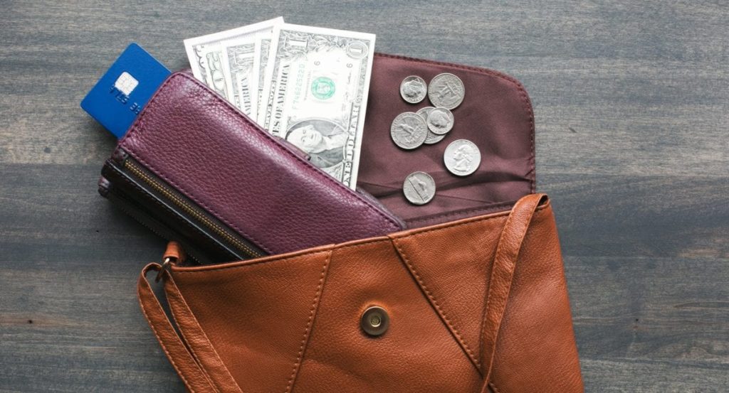 brown leather wallet with cash and credit cards
