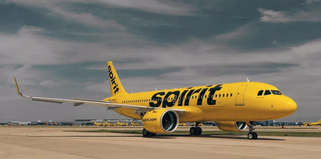 Spirit Airlines plane on the tarmac with gloomy skies